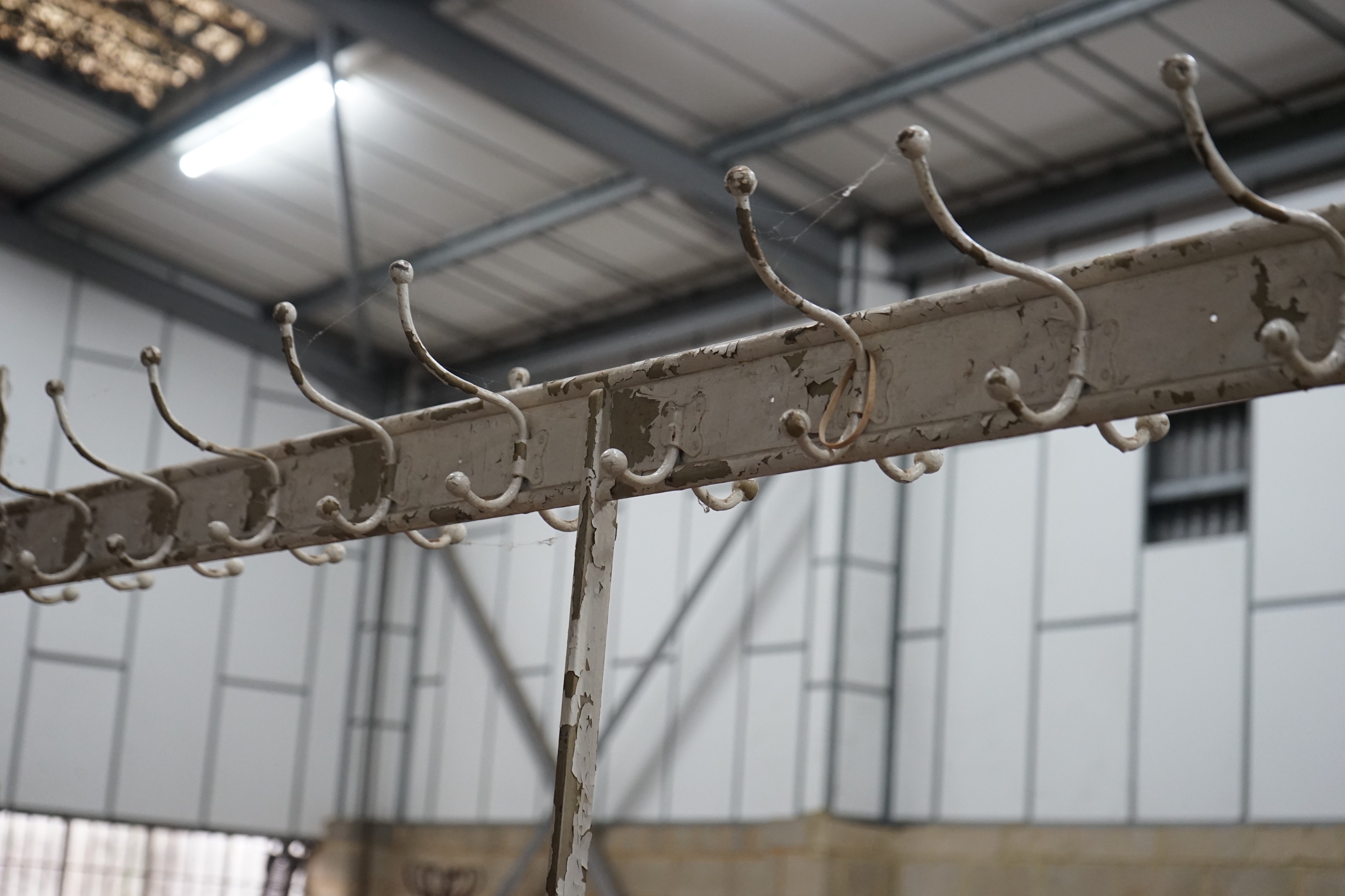 A vintage wrought iron coat and stick stand, width 200cm, height 206cm